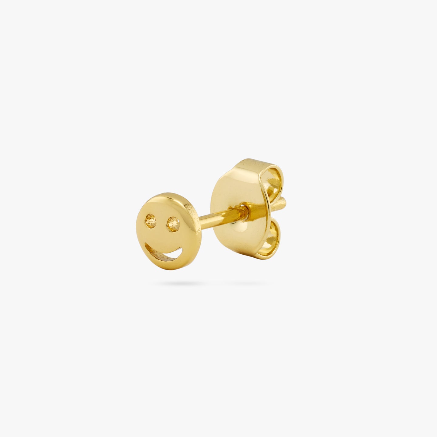 This is a small gold smiley face stud color:null|gold