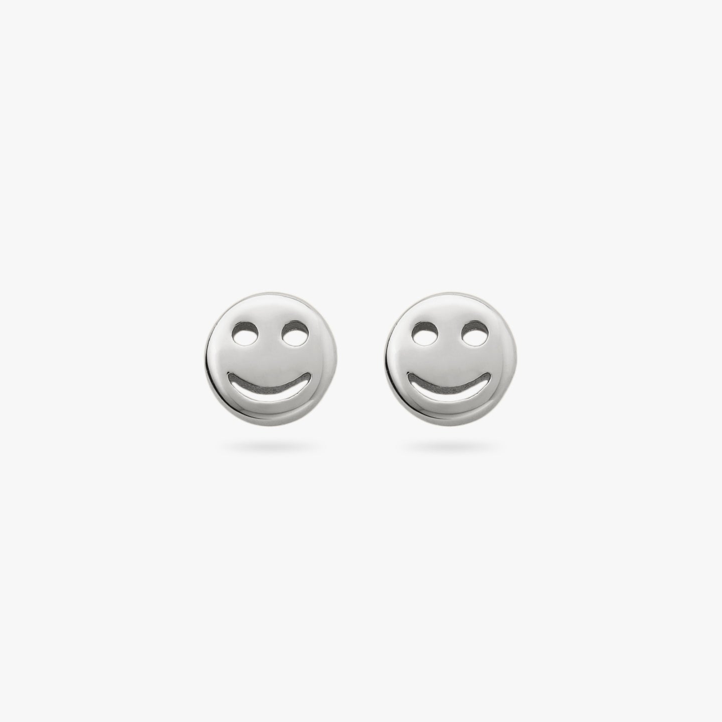 This is a pair of small silver smiley face studs [pair] color:null|silver