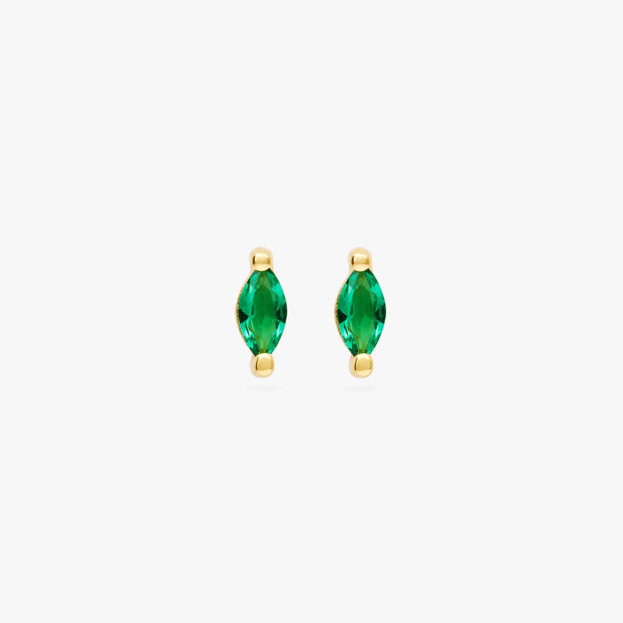 This is a pair of marquise mini studs that feature a green oblong shaped gem and has gold accents [pair] color:null|gold/green