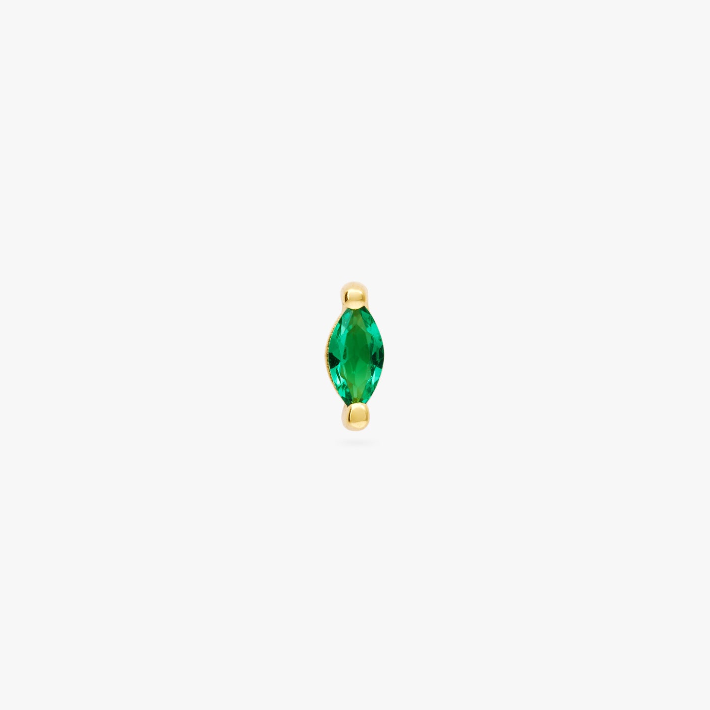 The marquise mini stud features a green oblong shaped gem and has gold accents color:null|gold/green
