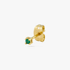 A mini gold stud with a green cz gem color:null|gold/green