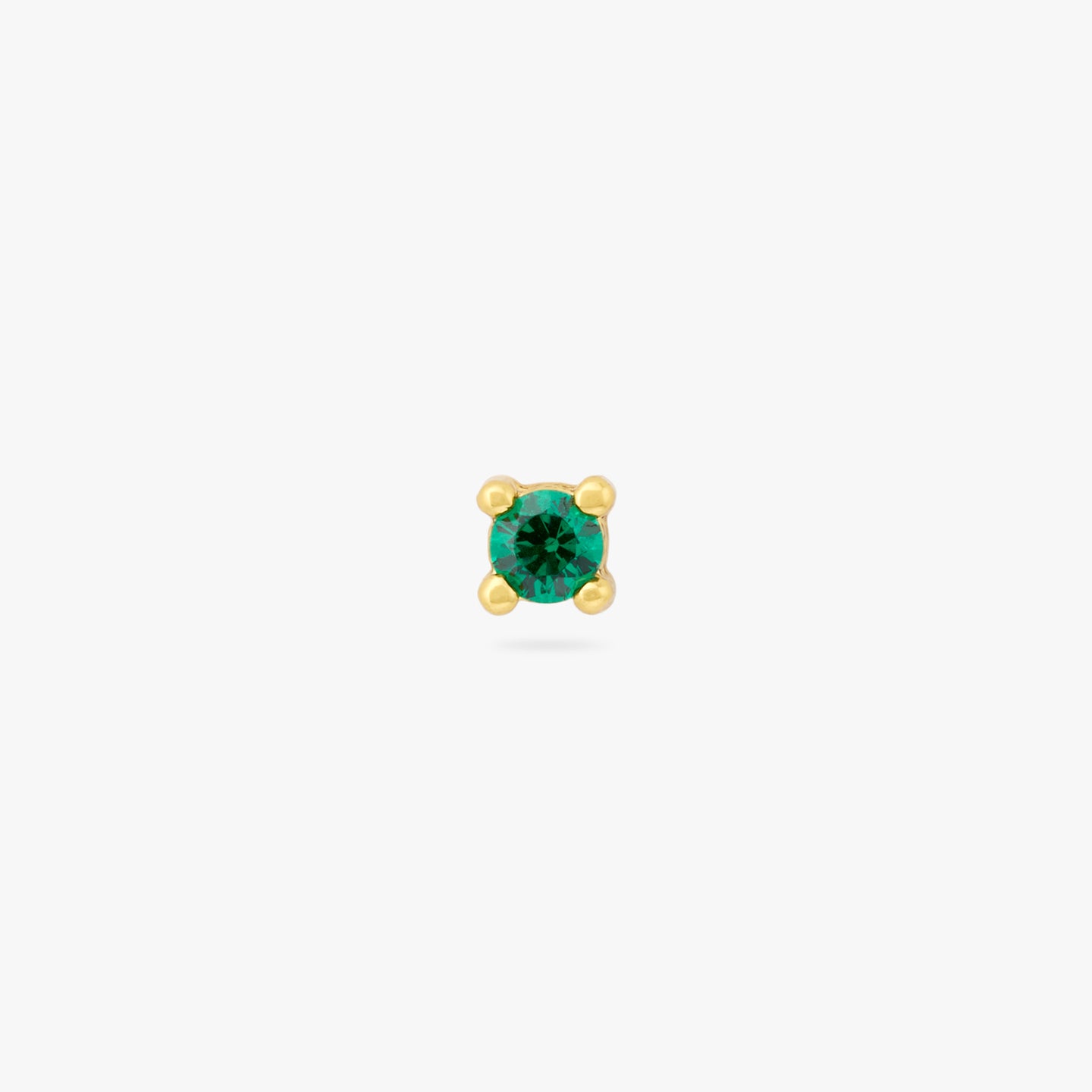 A mini gold stud with a green cz gem color:null|gold/green