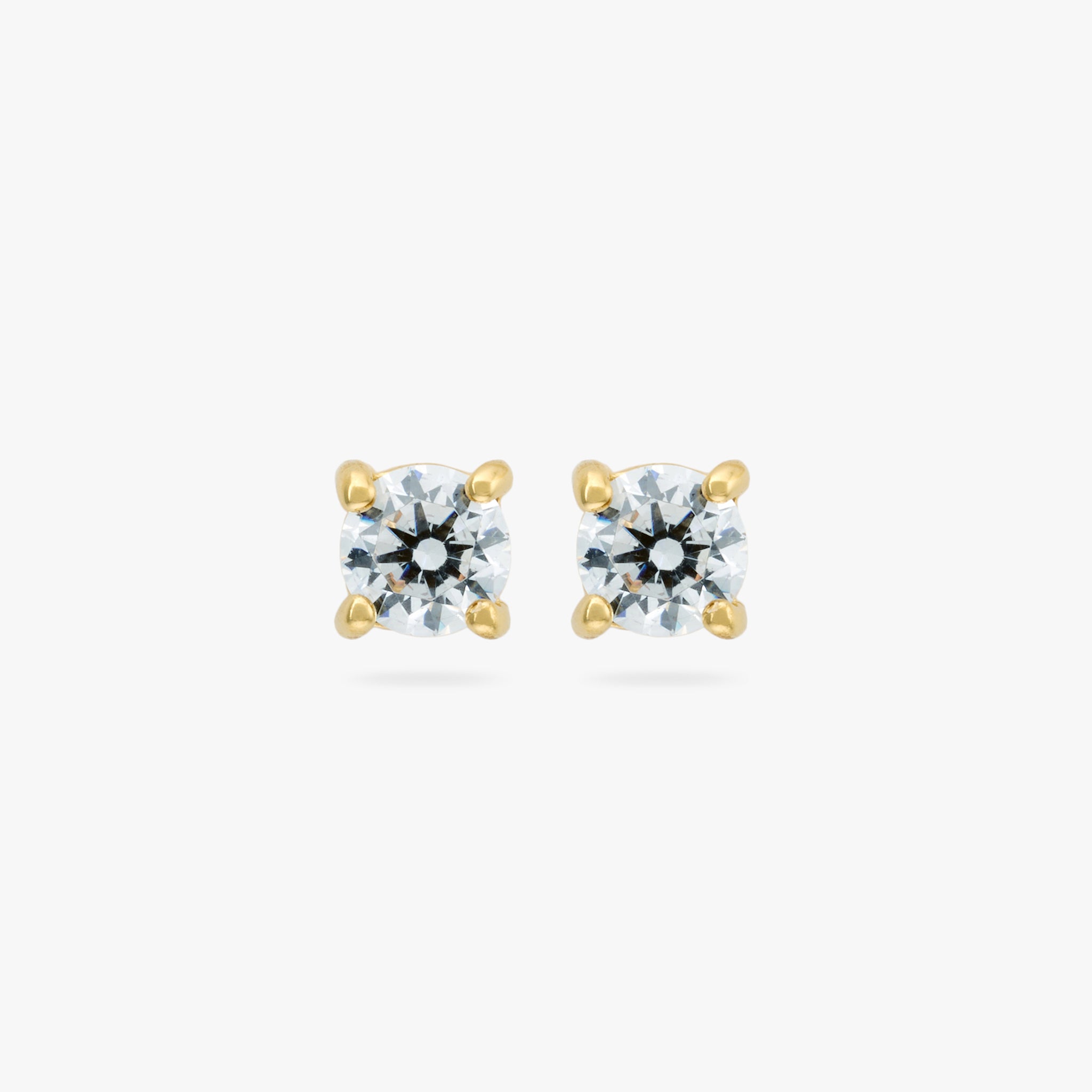 A pair of small CZ studs measuring 3mm. color:null|gold/clear