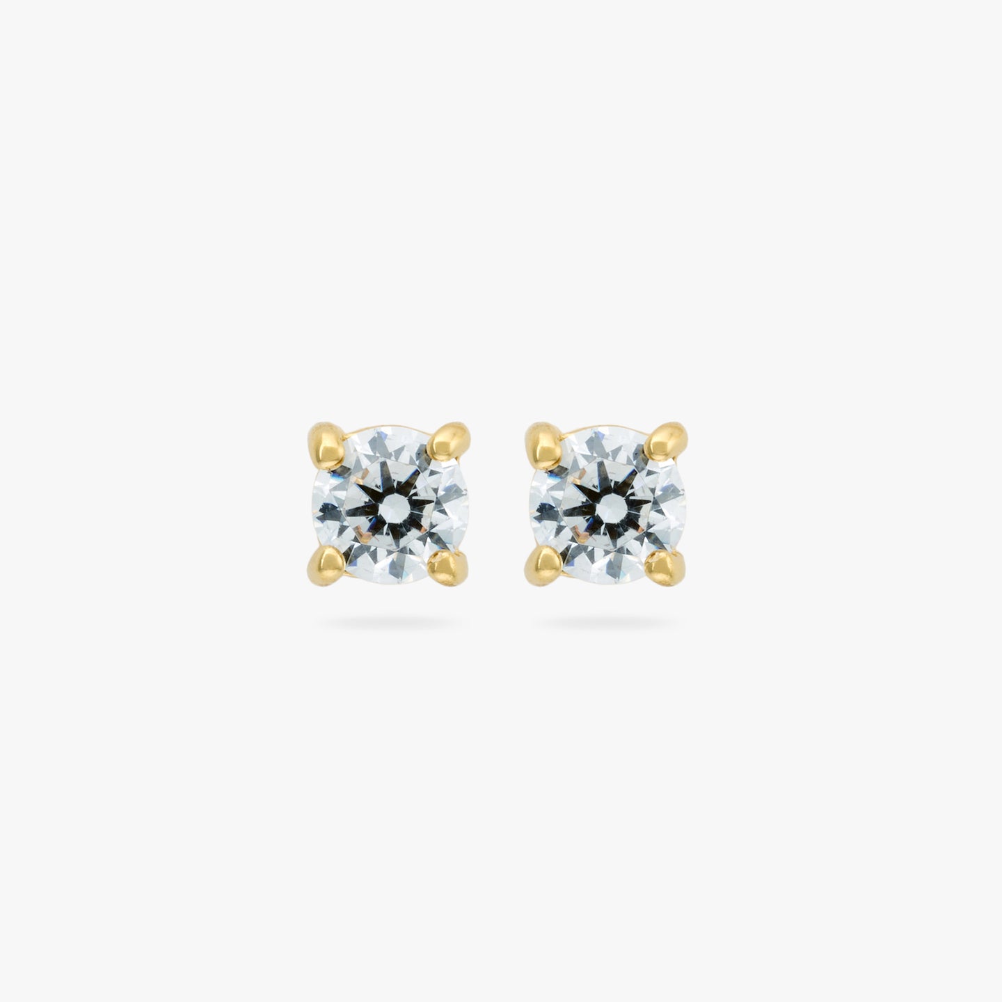 A pair of small CZ studs measuring 3mm. color:null|gold/clear