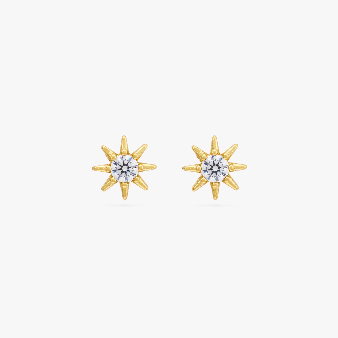 Gold circular shaped stud with very small spikes all around it and CZ gem in the center. [pair] color:null|gold/clear