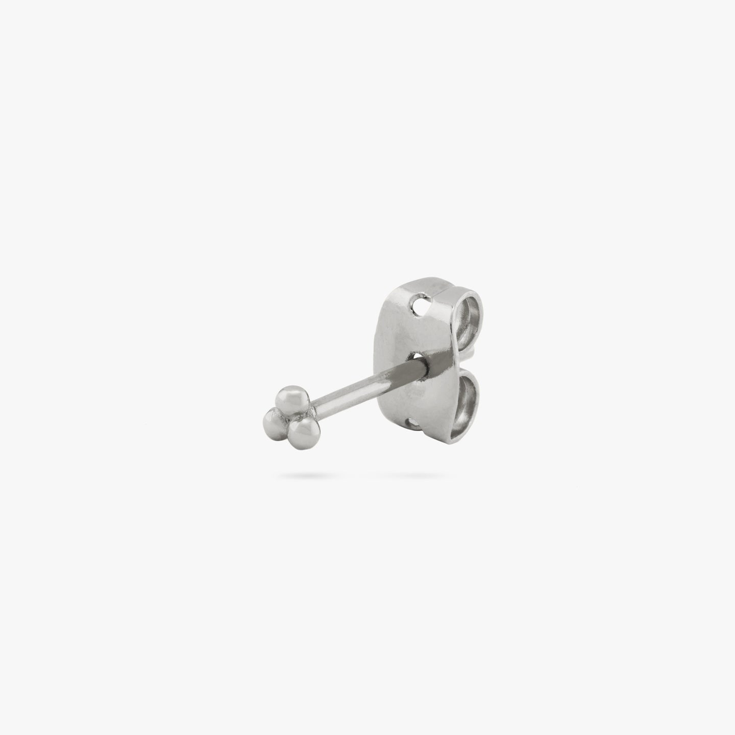 This is a small silver stud of three beads arranged in a cluster color:null|silver