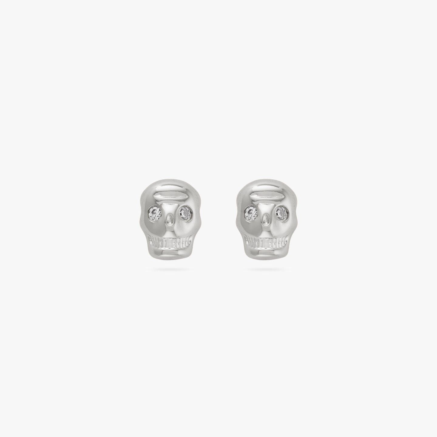 This is a pair of small silver skull stud with cz eyes color:null|silver