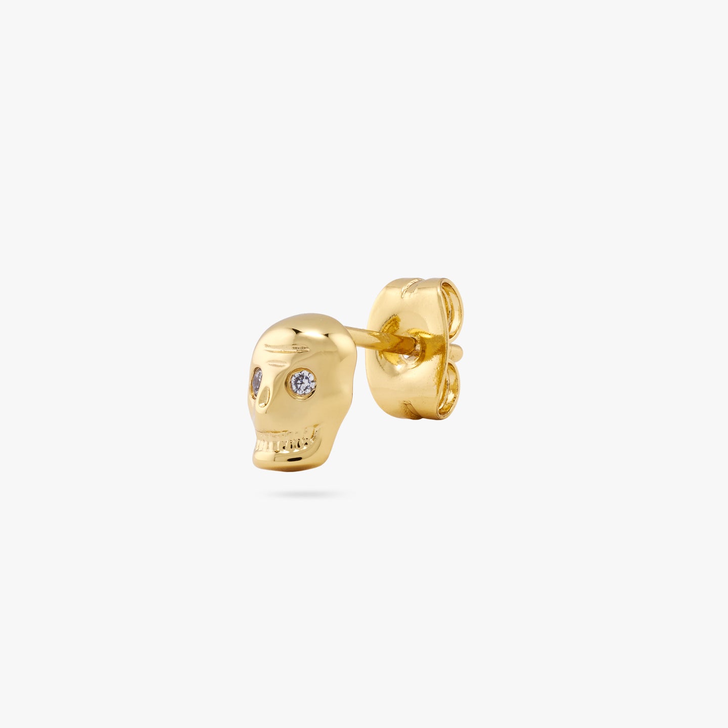 This is a small gold skull stud with cz eyes color:null|gold