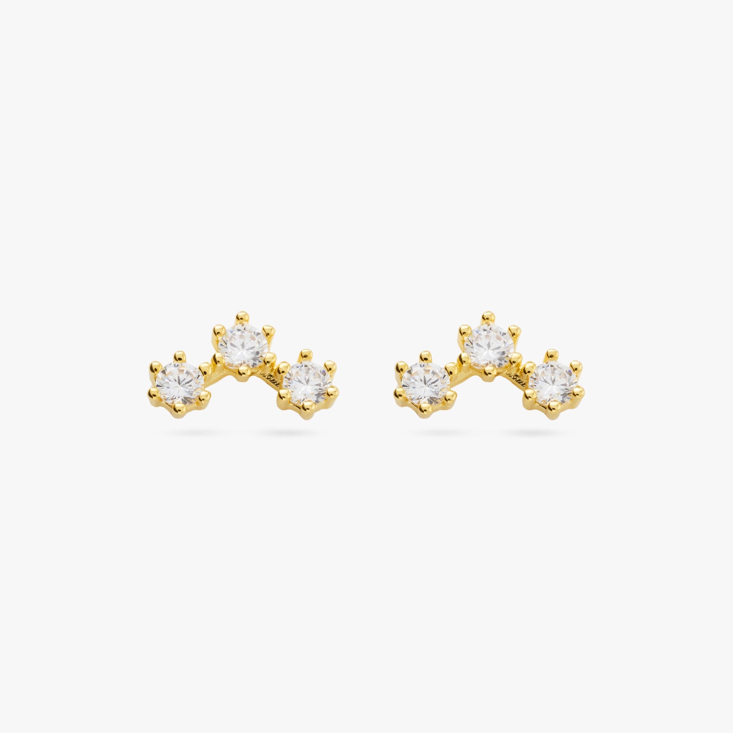 A pair of three cubic zirconia in an arch shaped gold cluster studs [pair] color:null|gold/clear