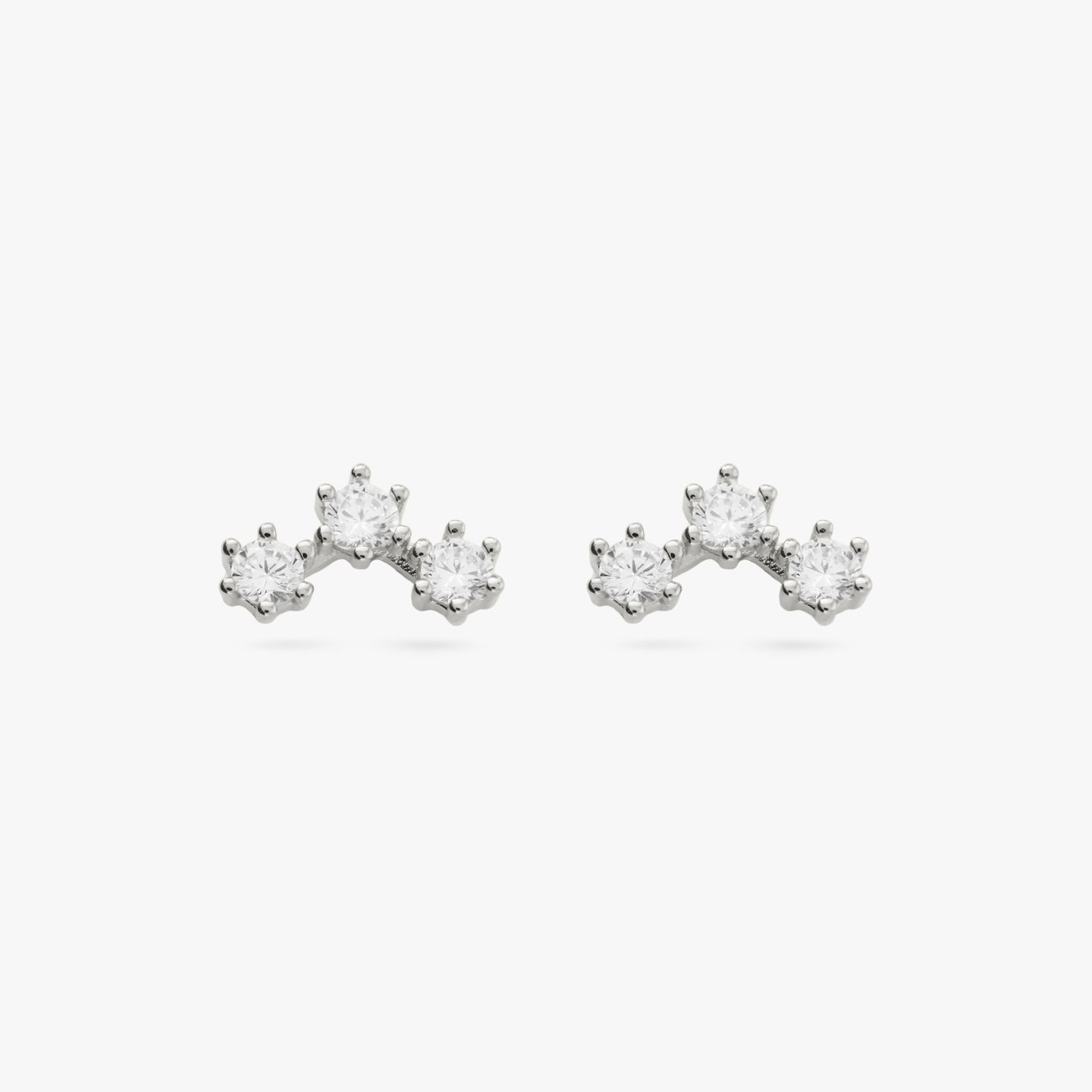 A pair of three cubic zirconia in an arch shaped silver cluster studs [pair] color:null|silver/clear