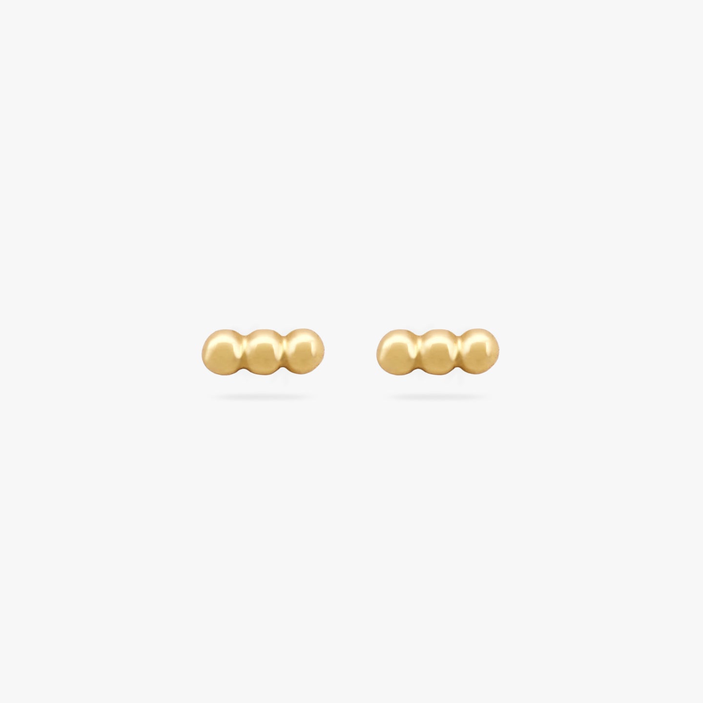A pair of three gold beads arranged in two bar studs. color:null|gold