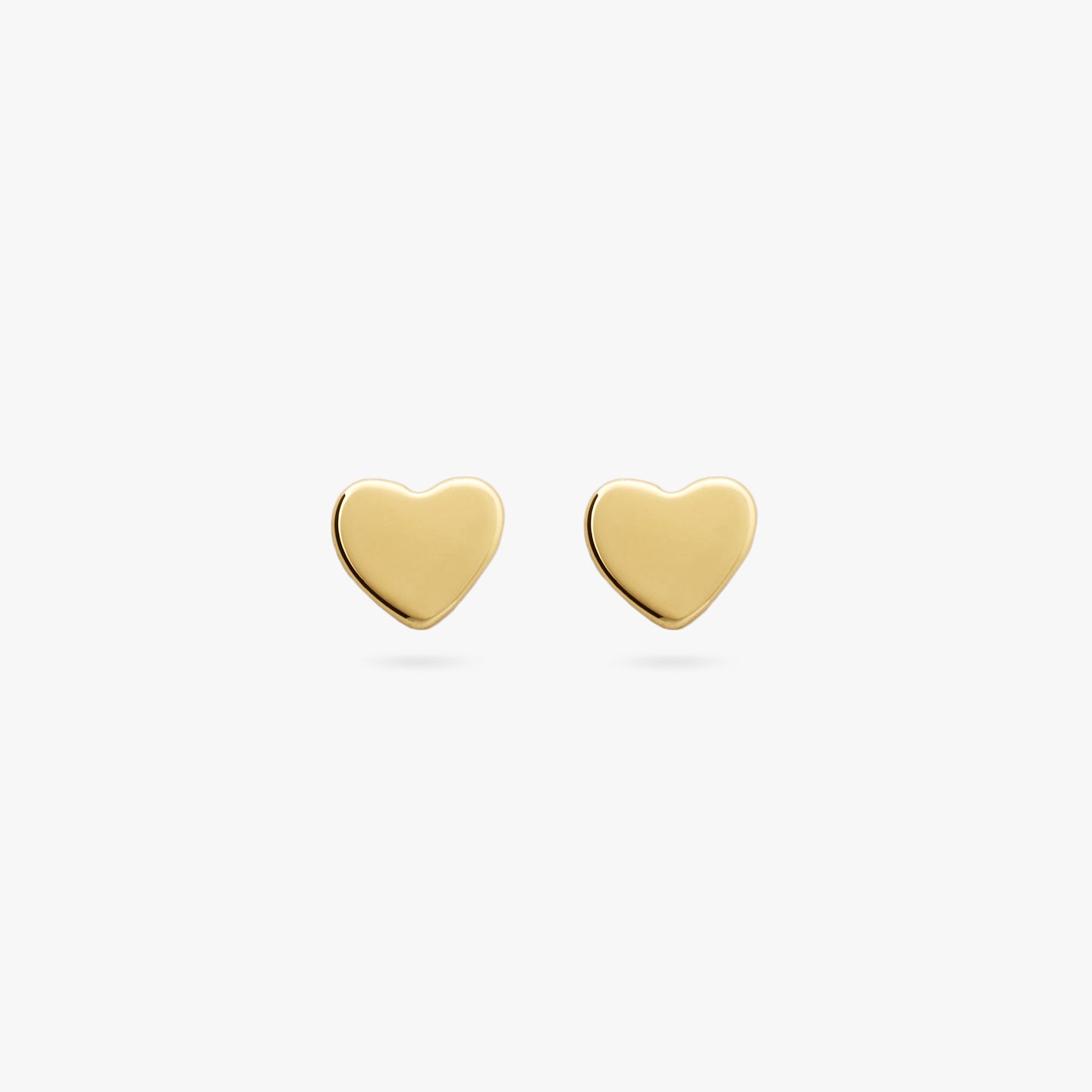 This is a pair of small gold studs in the shape of a heart [pair] color:null|gold