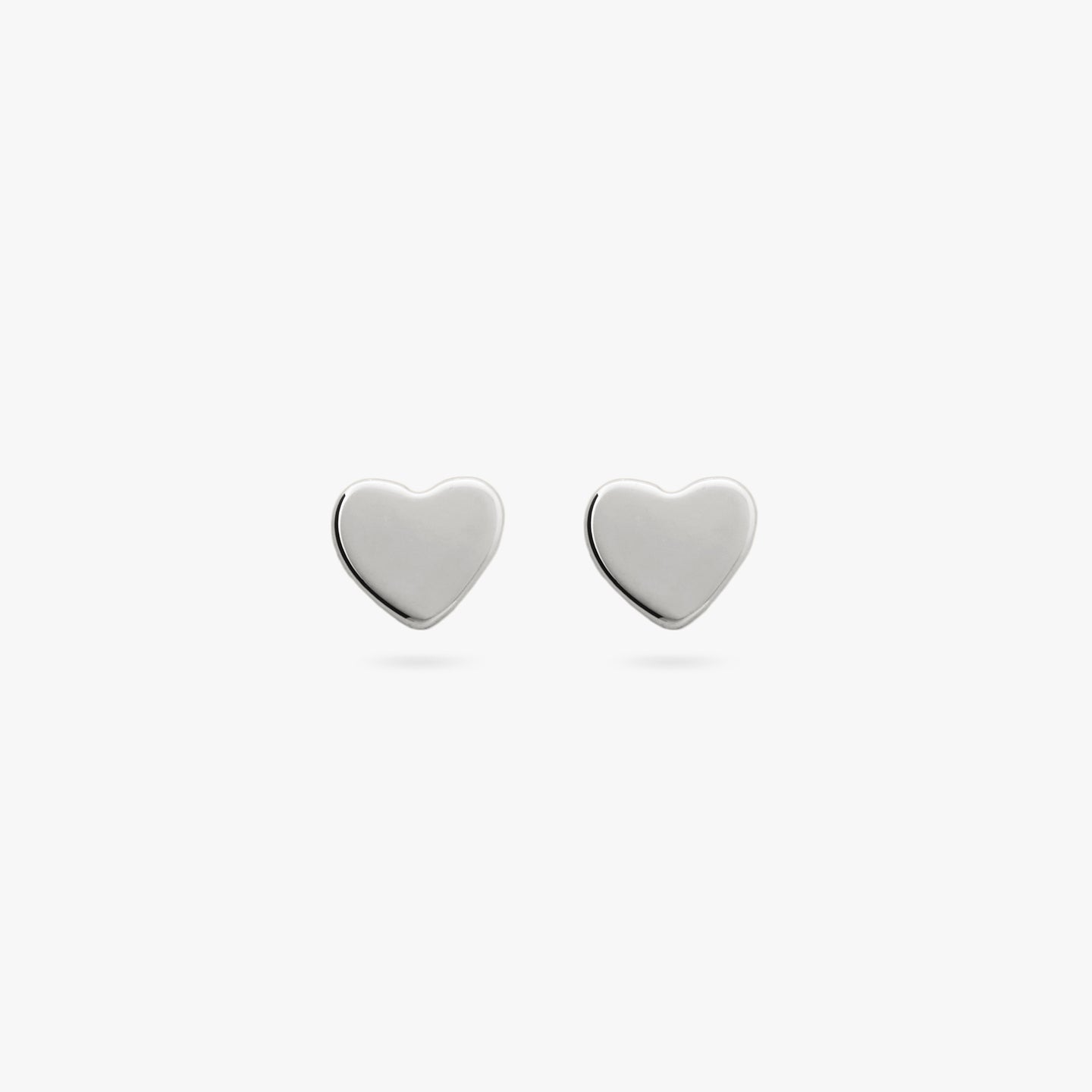 This is a pair of small silver studs in the shape of a heart color:null|silver