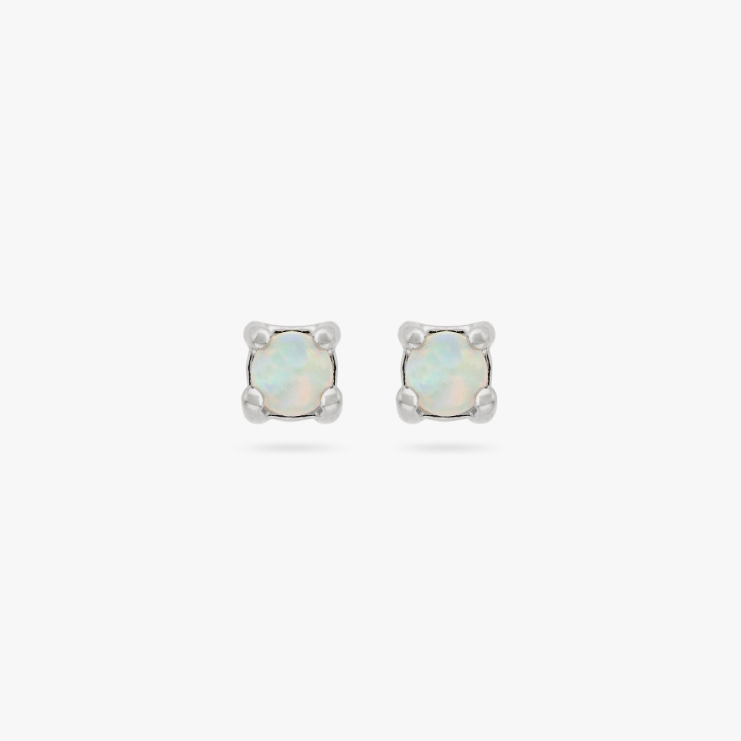 This is a pair of small silver studs with an opal [pair] color:null|silver/opal