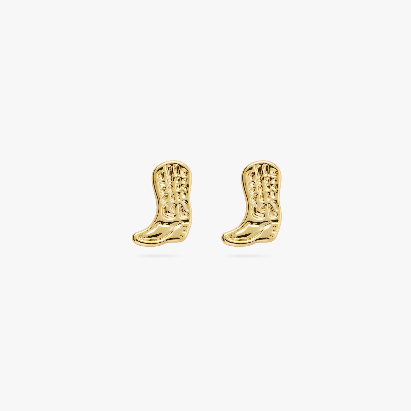 This is a pair of small gold cowboy boot shaped studs with detailing [pair] color:null|gold
