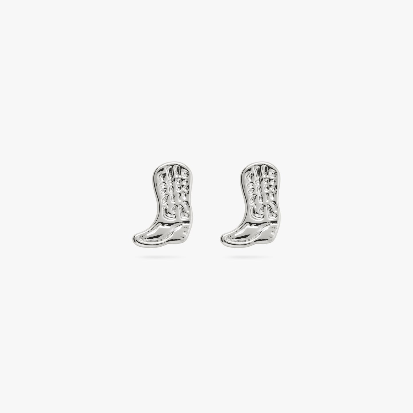 This is a small silver cowboy boot shaped stud with detailing [pair] color:null|silver