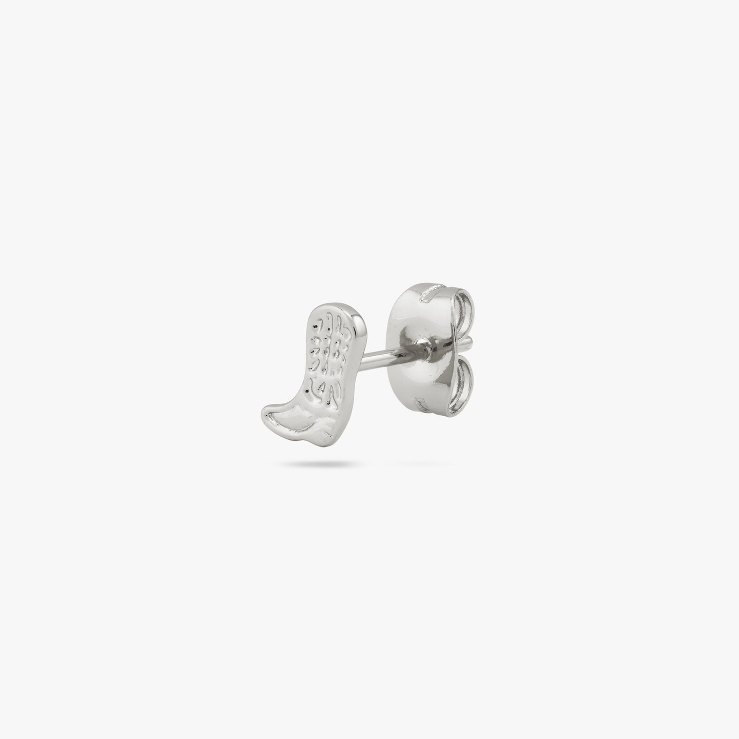 This is a small silver cowboy boot shaped stud with detailing color:null|silver