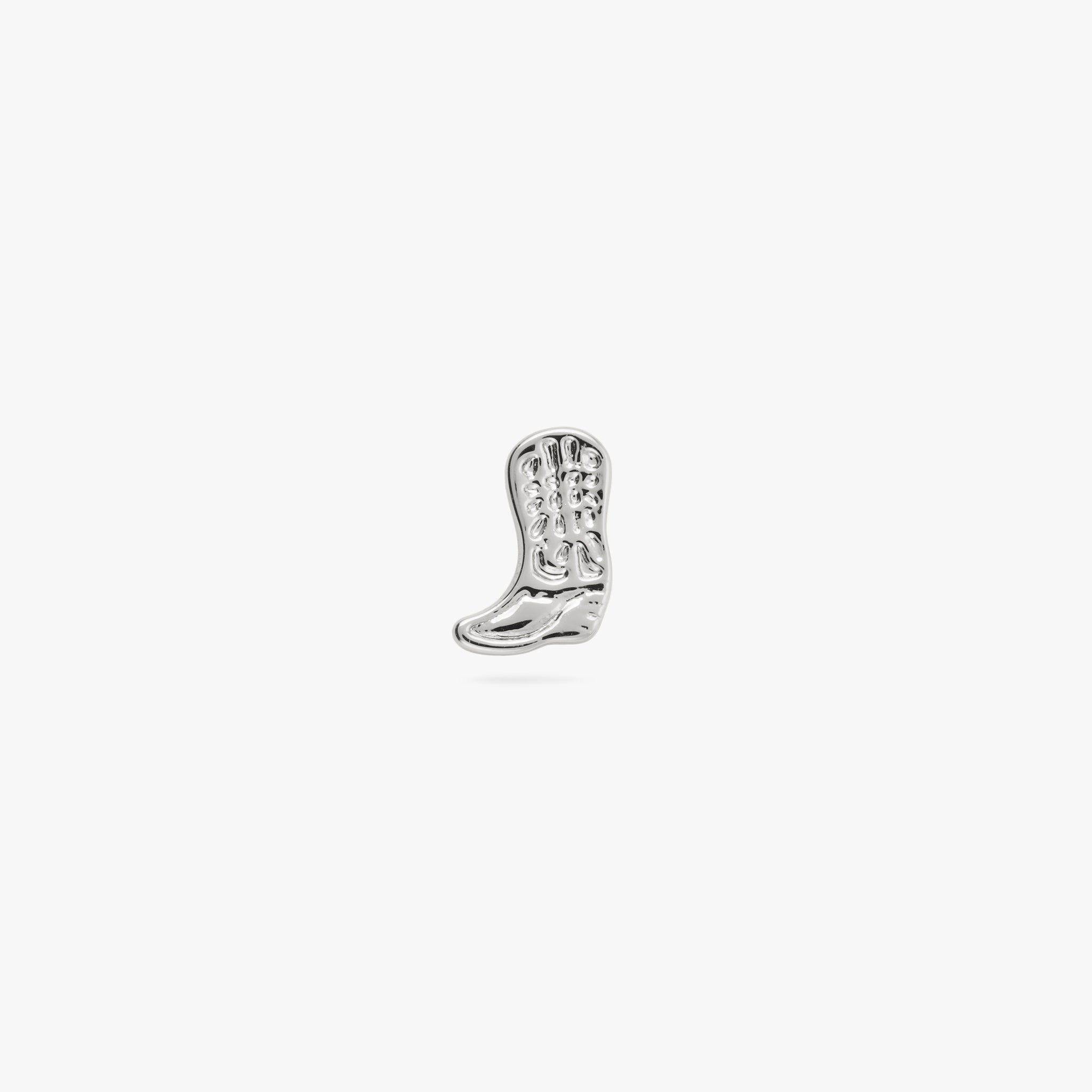 This is a small silver cowboy boot shaped stud with detailing color:null|silver