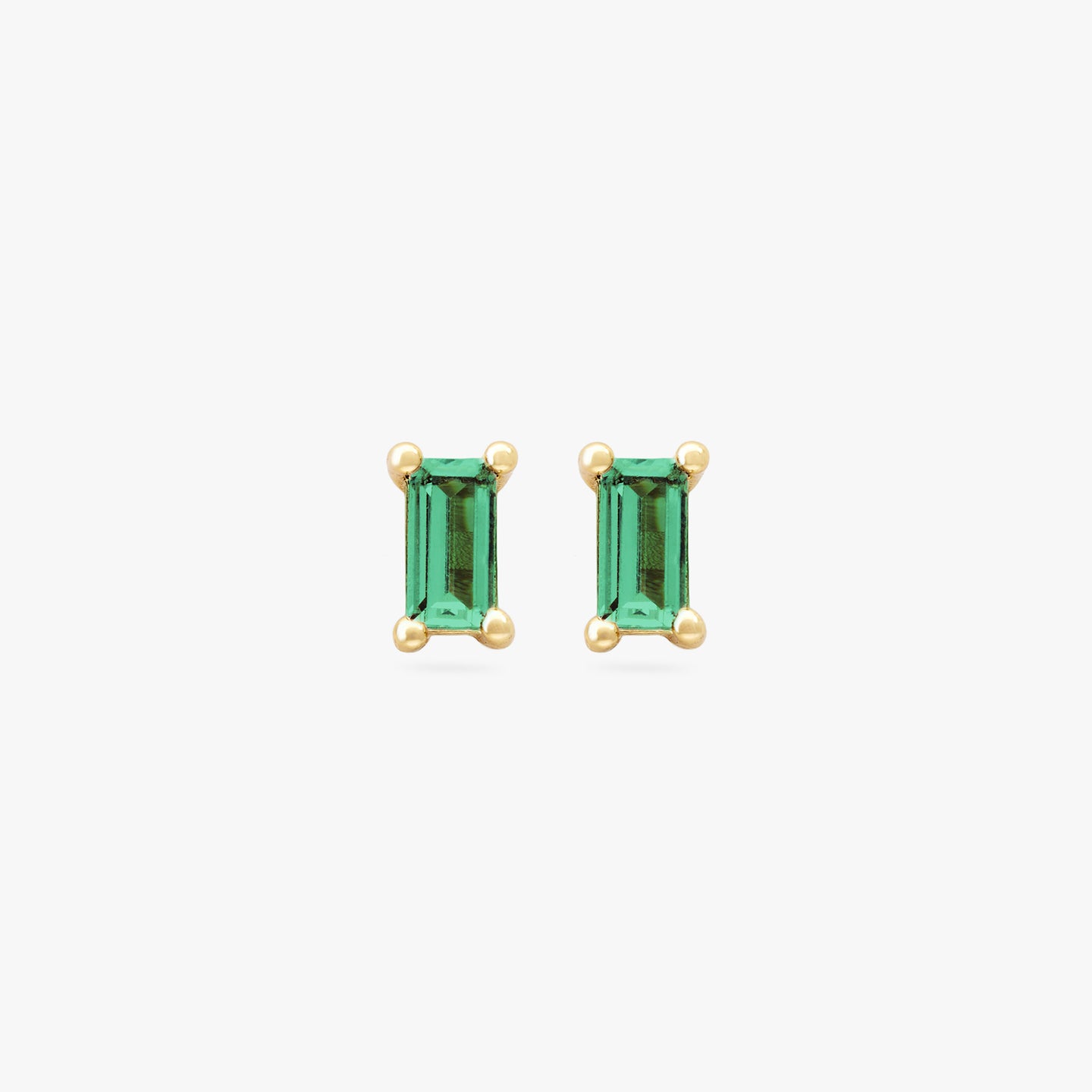 This is a pair of gold baguette studs with a green CZ gems [pair] color:null|gold/green