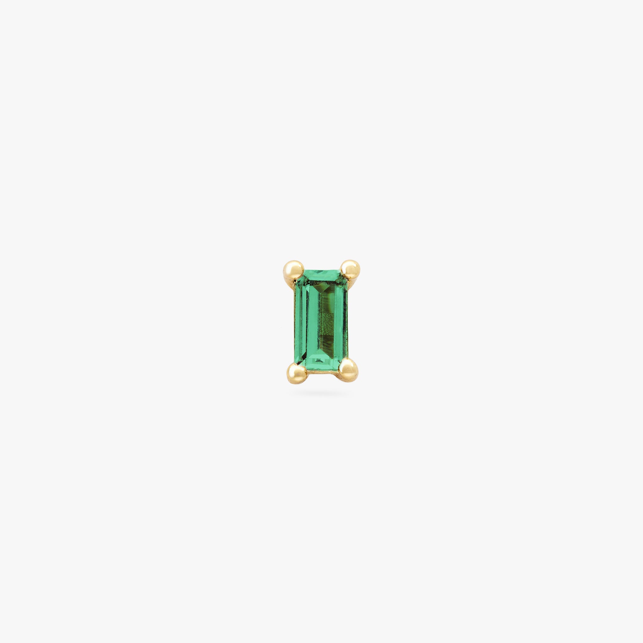 This is a gold baguette stud with a green CZ gem color:null|gold/green