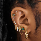 a gold plated stud in the shape of a daisy with a color changing mood stone [hover] color:null|gold