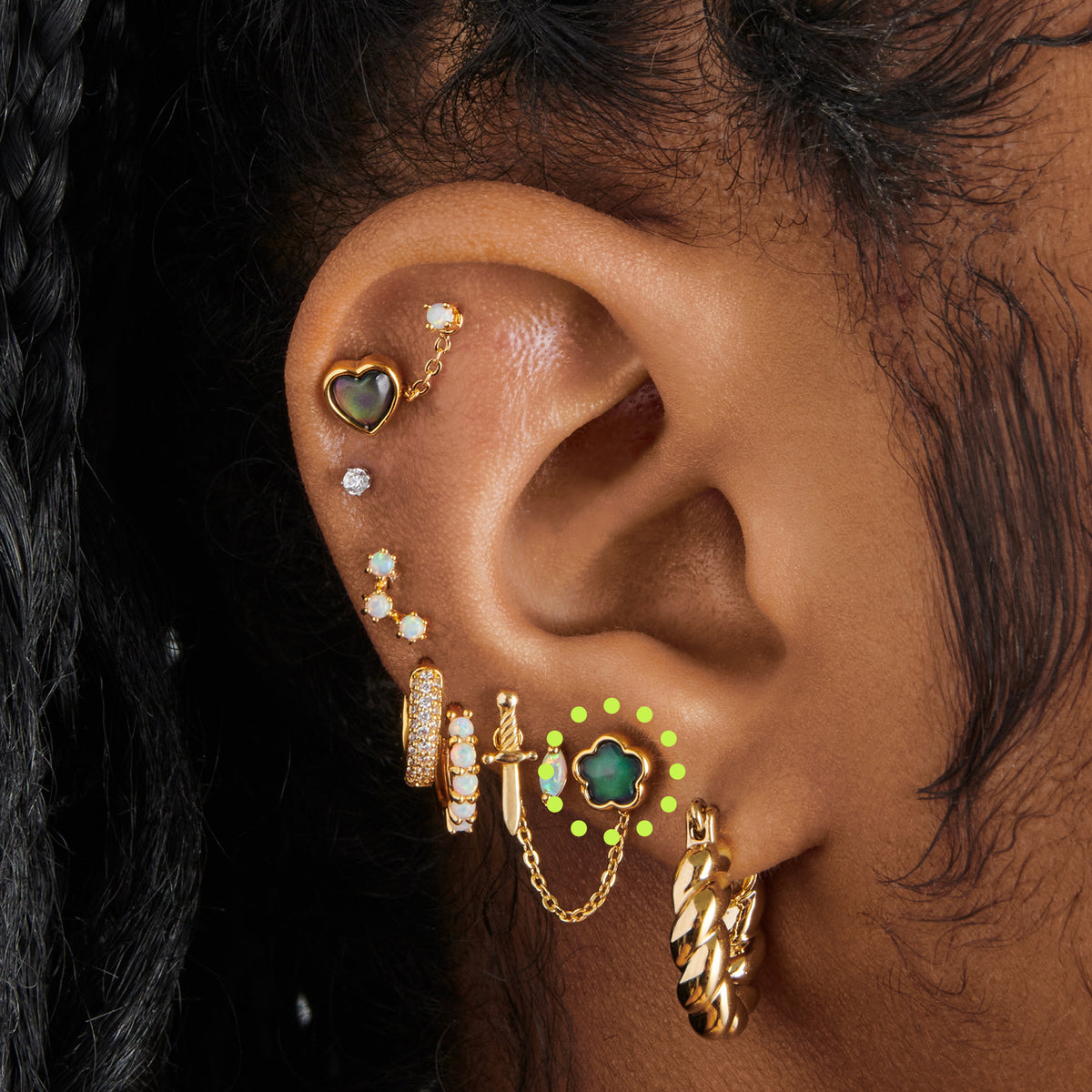 a gold plated stud in the shape of a daisy with a color changing mood stone [hover] color:null|gold