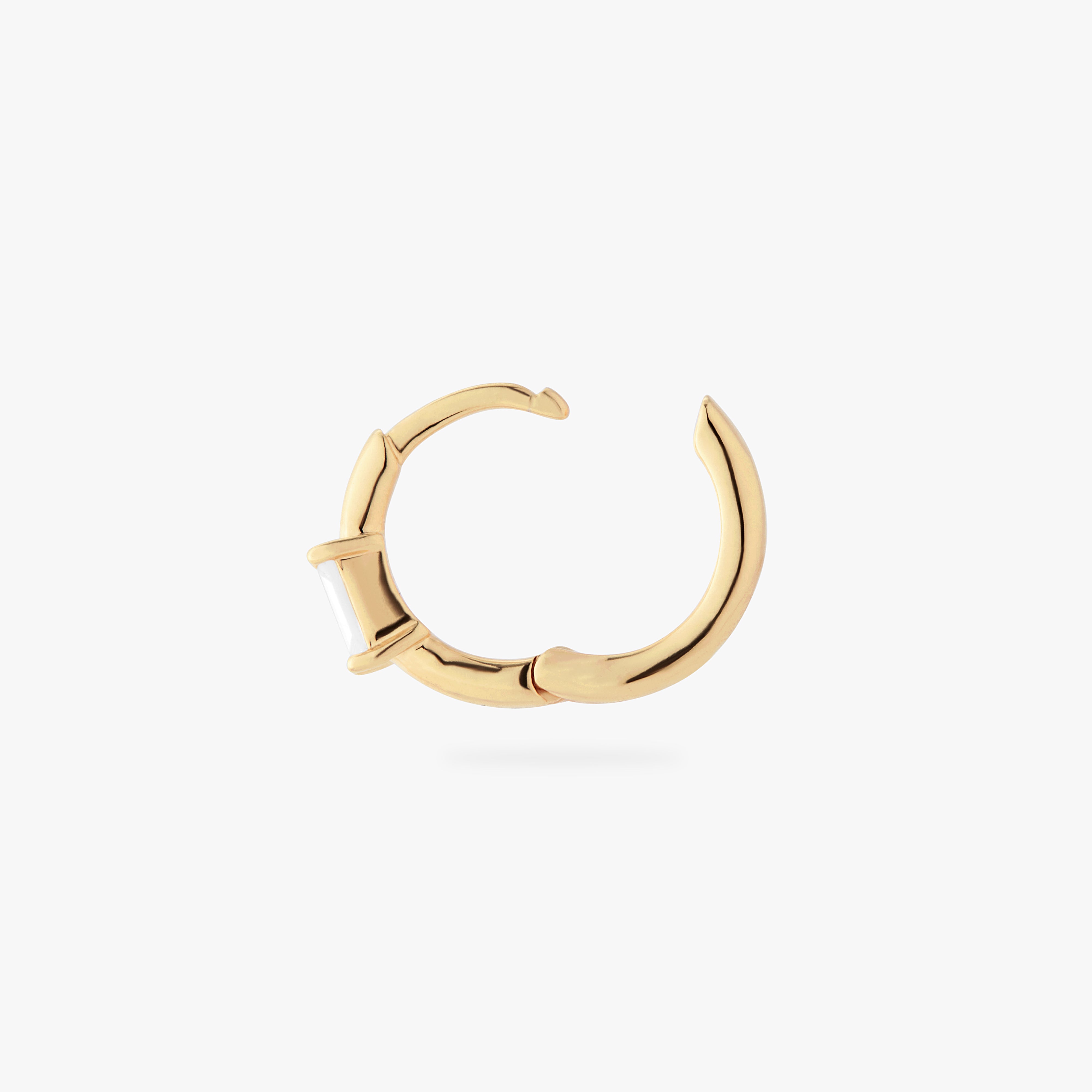 a gold small slim huggie with a clear baguette cz color:null|gold/clear