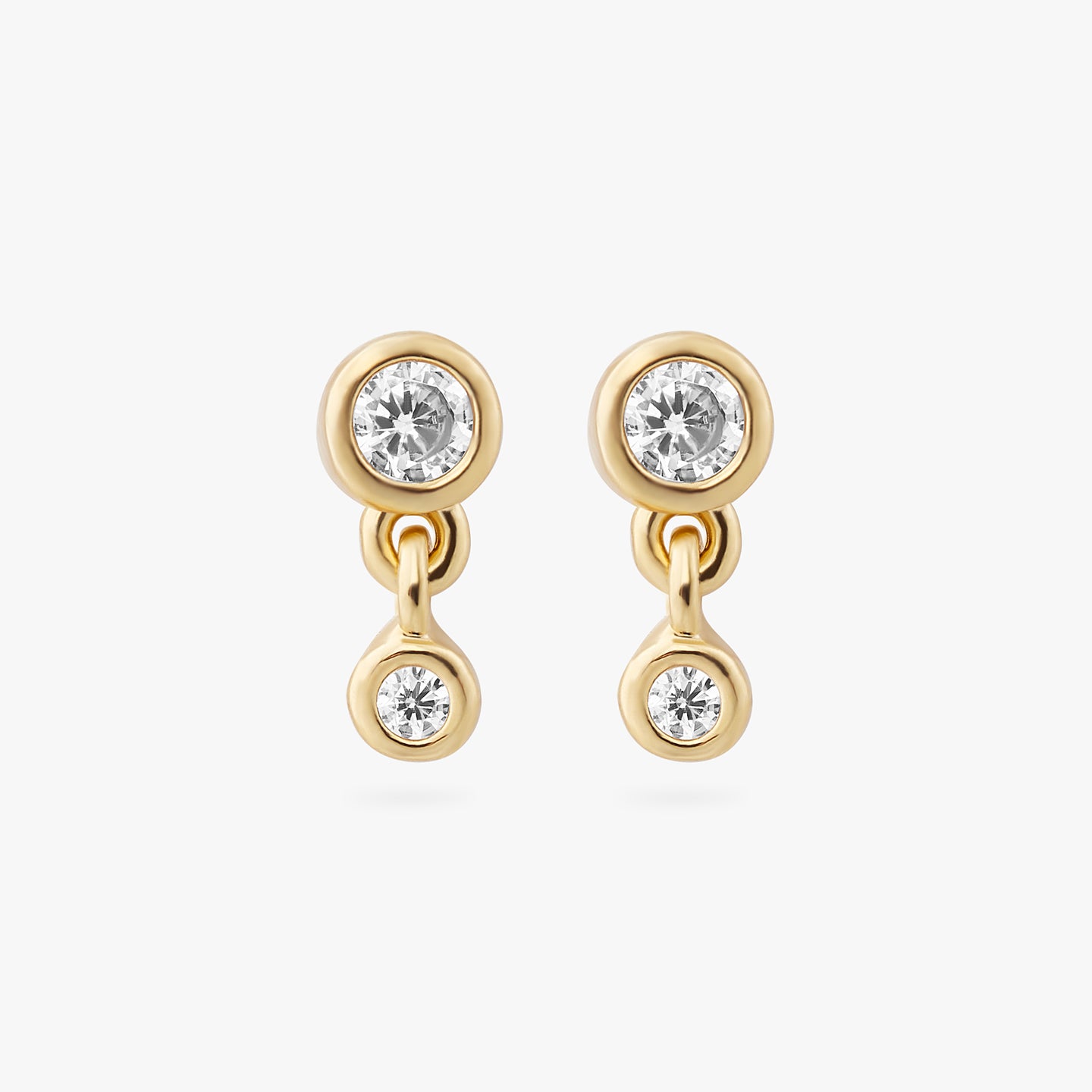 a pair of gold plated bezel studs with clear cz and another clear bezel cz hanging from them [pair] color:null|gold/clear