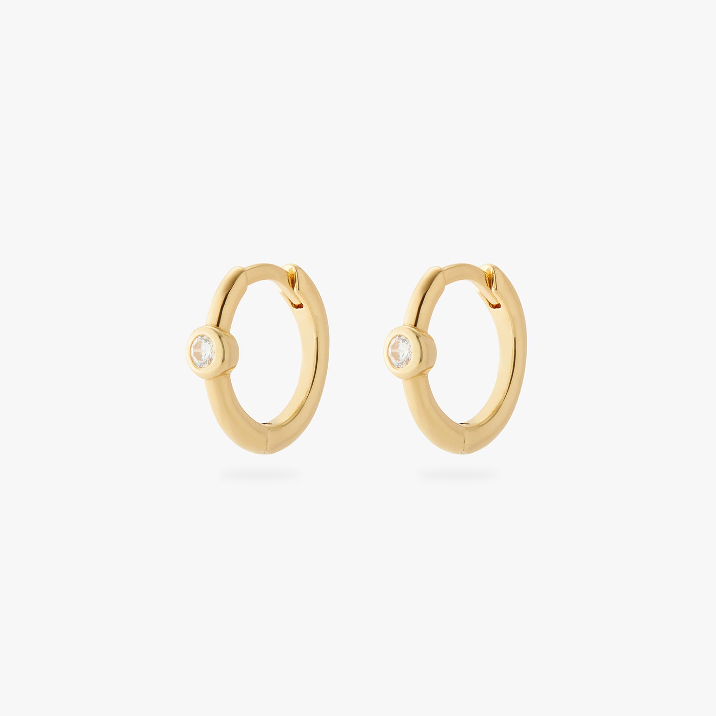 a pair of gold small slim huggies with clear cz bezels [pair] color:null|gold/clear