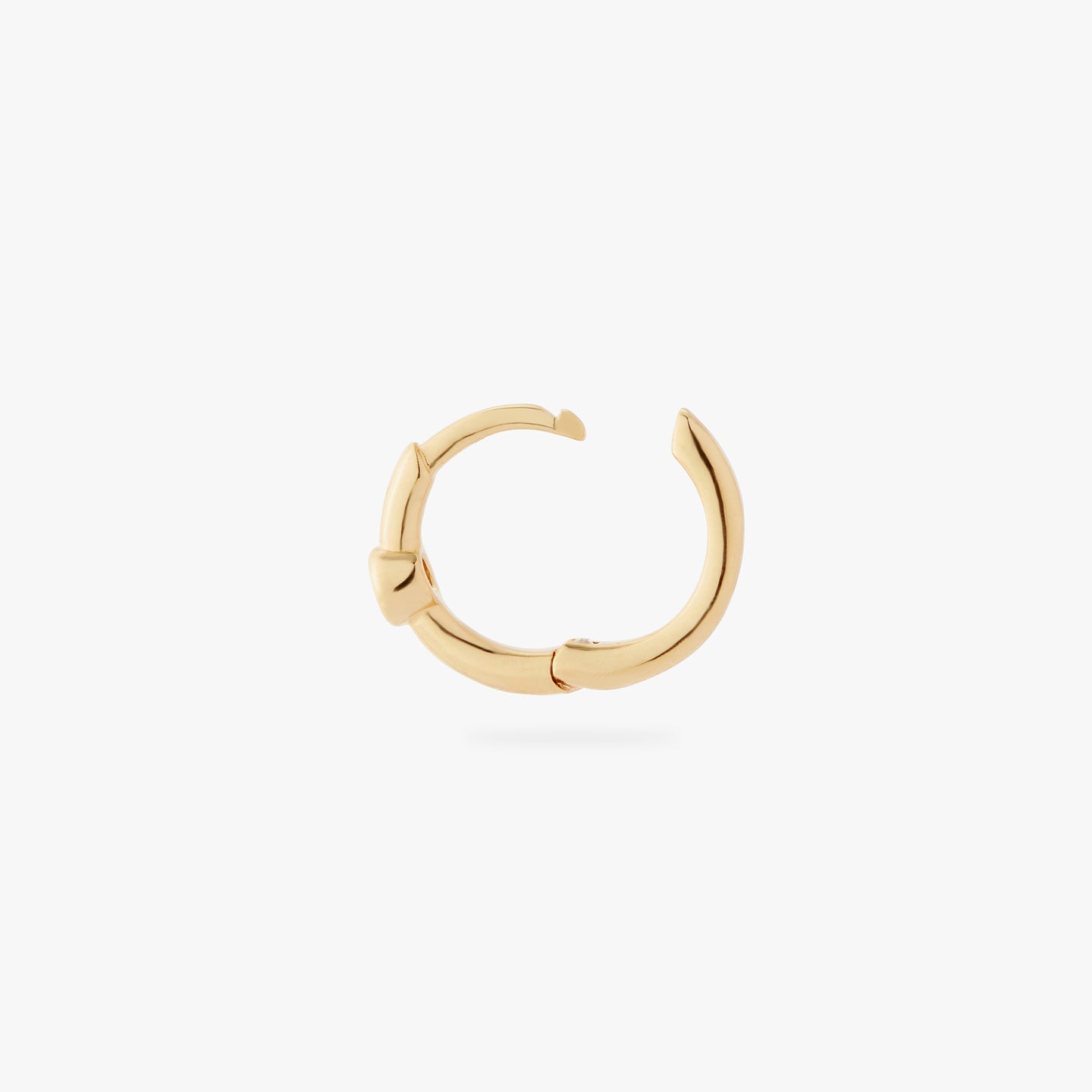 a gold small slim huggie with a clear cz bezel color:null|gold/clear
