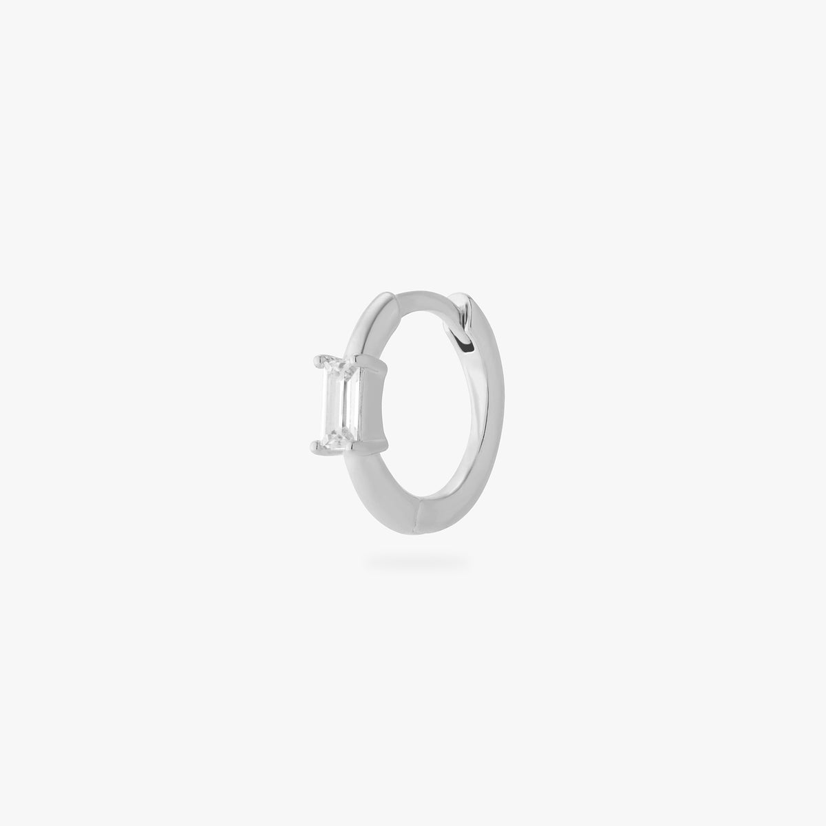 a silver small slim huggie with a clear baguette cz color:null|silver/clear