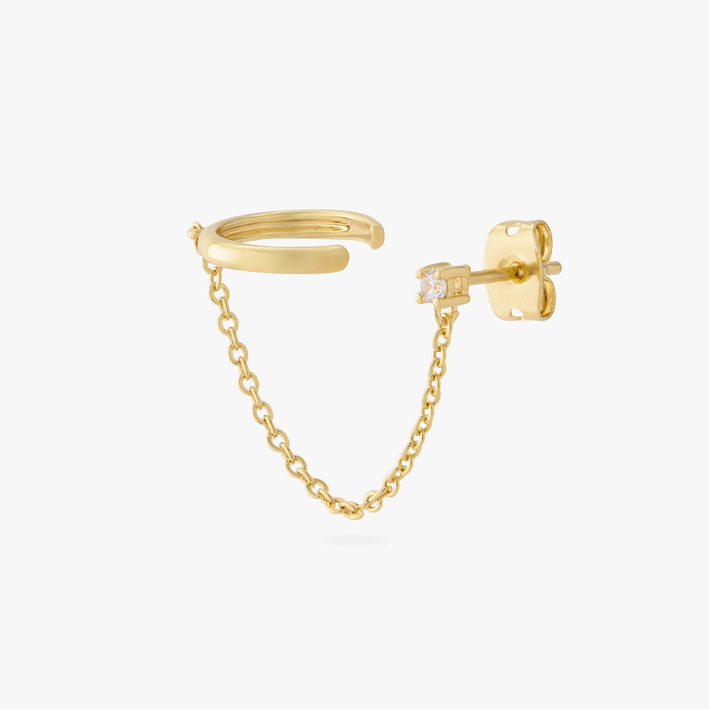 a gold cz stud with a chain connecting it to a gold slim cuff color:null|gold/clear