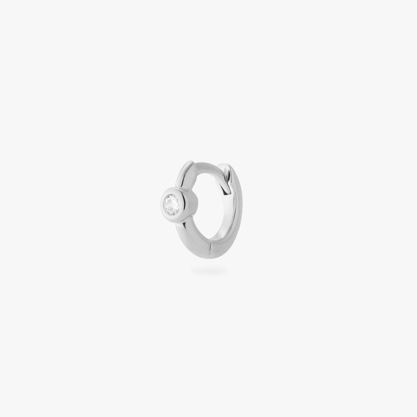a silver micro helix huggie with a clear bezel color:null|silver/clear